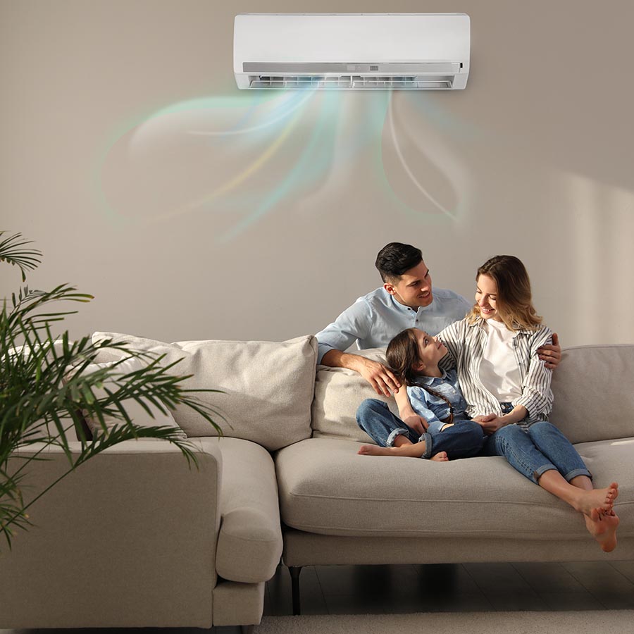 Family sitting on a couch with ductless mini split