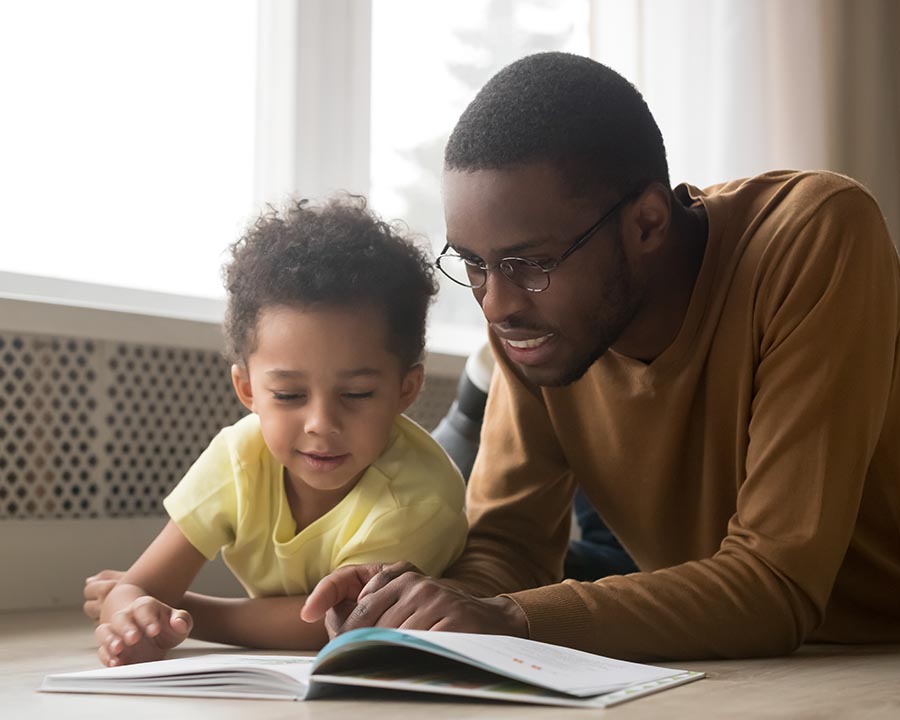 Father and son reading a children's book